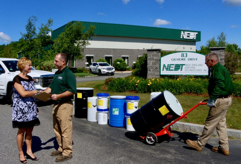 An NEDT member and Board of Health member shaking hands in front of the NEDT office.