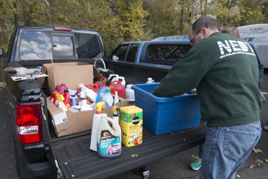 NEDT staff unloaded a truck of hazardous household products not allowed in the trash.